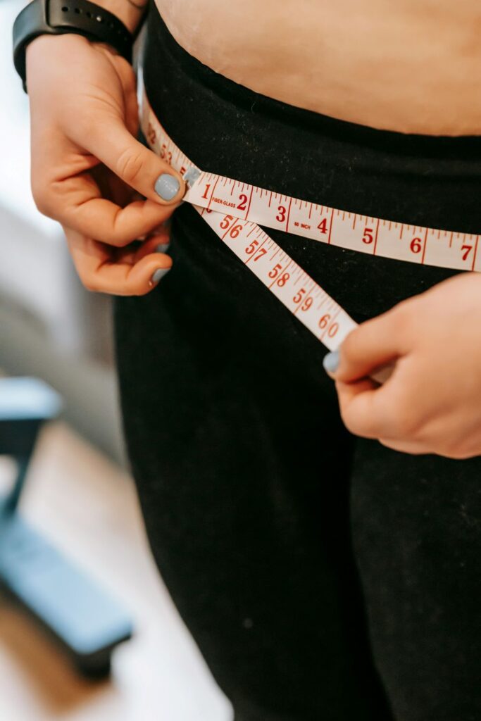 Woman measuring her hips
