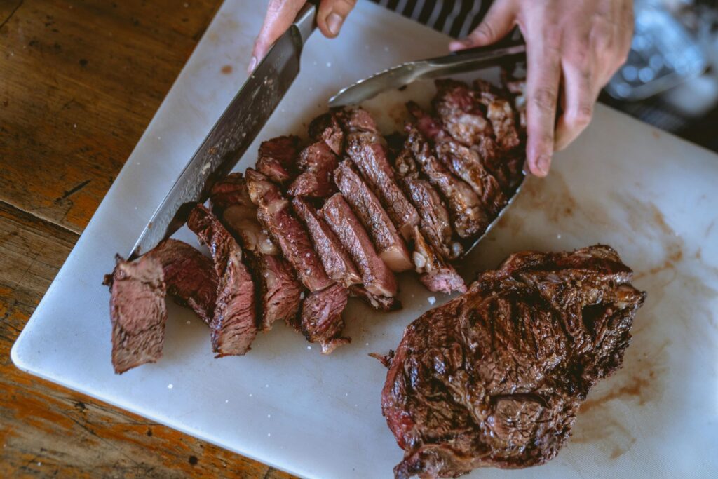 Person Slicing Cooked Meat