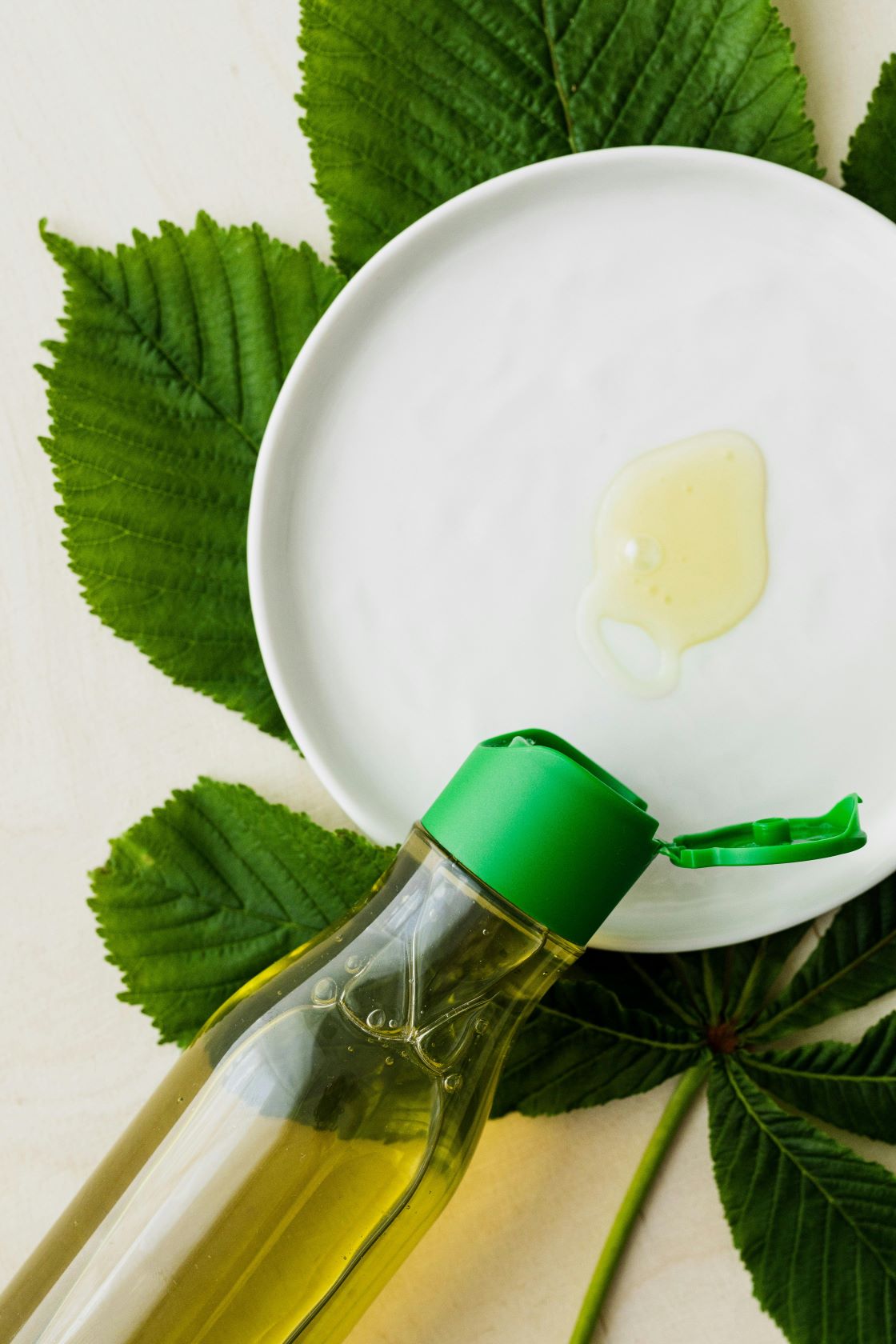 Essential oil in bottle and on white plate
