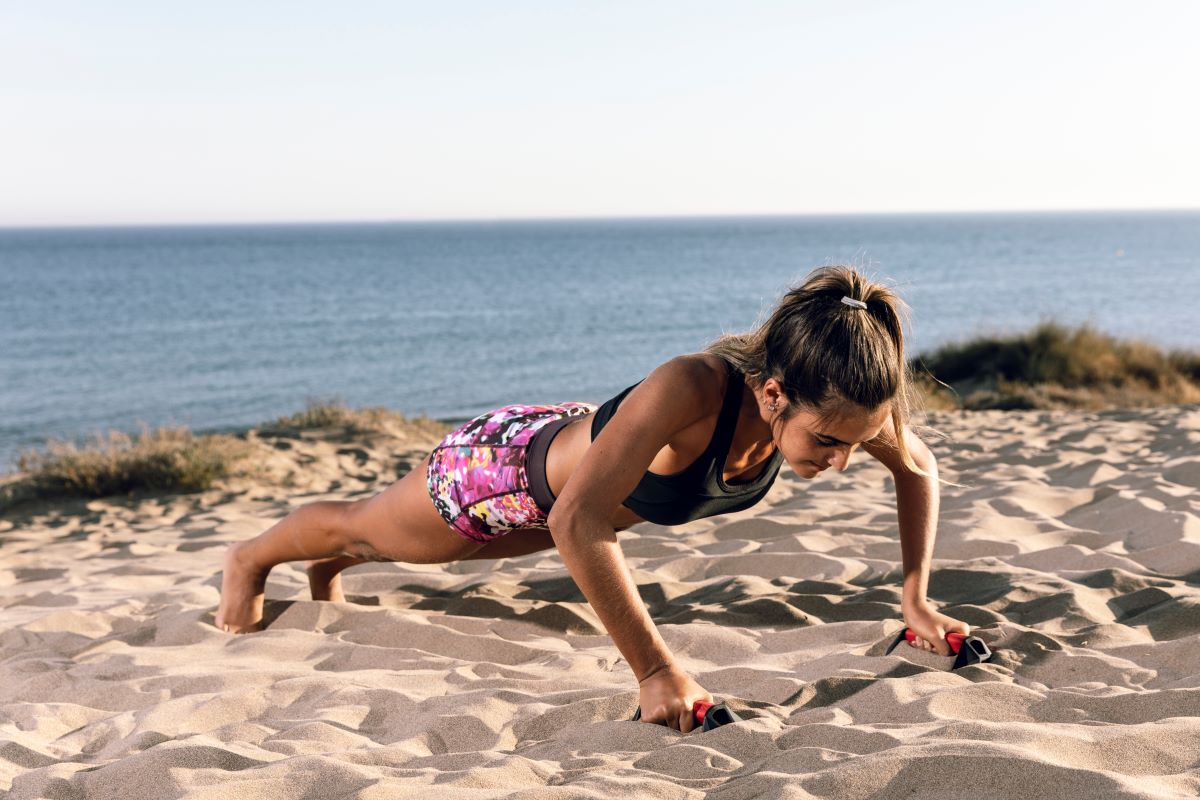 Woman in sportswear doing push ups
